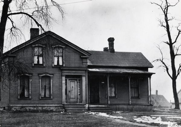 View of Stewart house from the northwest. Building has two front doors, with a porch over the one on the right.