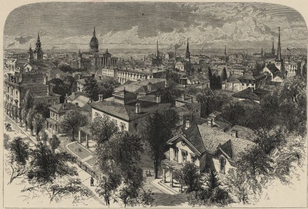 Elevated view over residential area, with several churches in the background.