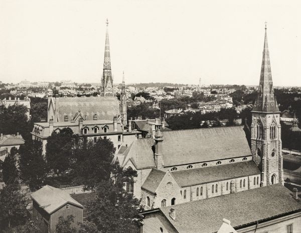 Elevated view, looking northwest from the Fourth District Schoolhouse.  The foreground is dominated by two large churches.