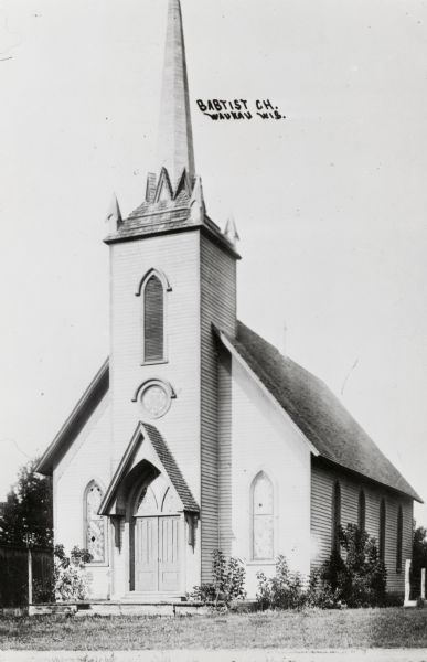Exterior view of the church. Built in 1867, it was dismantled in 1914. Caption reads: "Babtist [sic] Ch. Waukau Wis."