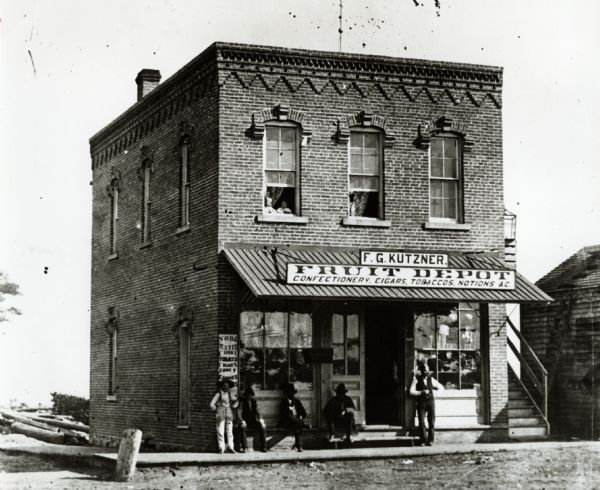 Store was at the west end of first Chippewa bridge. Kutzner was also toll keeper of the bridge.  Two children are looking out of left window on the second floor.