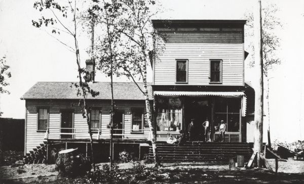 Store includes a Post Office, owned by Cyrus Yawkey.  Men, child, and two dogs are on the porch.