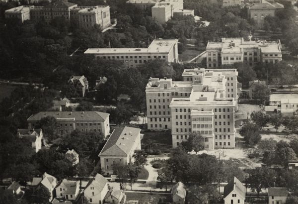 University of Wisconsin-Madison buildings. The General Hospital is in the center, surrounded by homes, trees, and other university buildings.