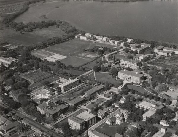 University of Wisconsin-Madison campus on isthmus, including the Agricultural campus and men's dormitories. Part of Lake Mendota is in the top right corner.