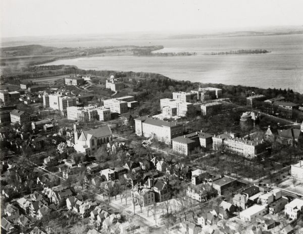 University of Wisconsin-Madison aerial view overlooking the lower campus and surrounding neighborhoods. Lake Mendota and Picnic Point are in the background.