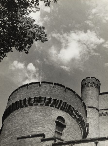 Armory tower with crenels and narrow arched windows. The building is on the University of Wisconsin-Madison campus and is also known as the Red Gym or Old Red.