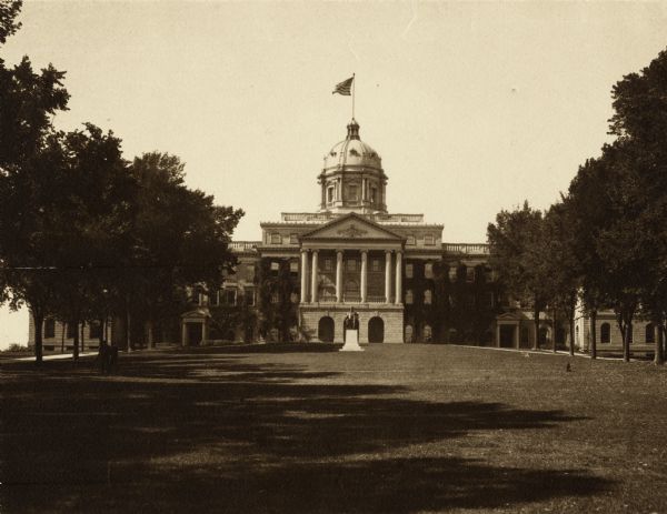 Exterior of Bascom Hall (formerly Main Hall) on the University of Wisconsin-Madison campus. A flag is flying from the dome, and the Lincoln Statue is in front of the entrance.