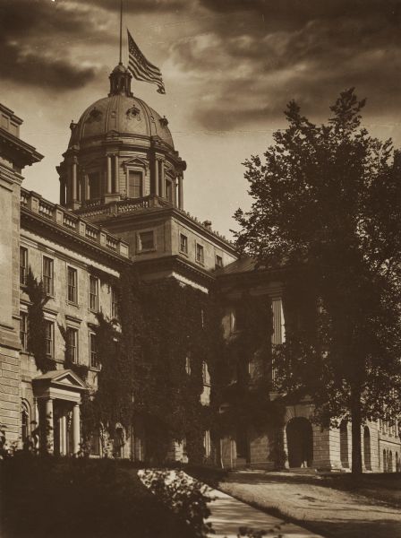 Exterior side view of Bascom Hall with dome (formerly Main Hall) on the University of Wisconsin-Madison campus. The flag on top of the dome is at the lowest point on the pole.