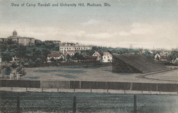View over Camp Randall Stadium towards University Hill on the University of Wisconsin-Madison campus. Bascom Hall is visible in the distance. Caption reads: "View of Camp Randall and University Hill, Madison, Wis."