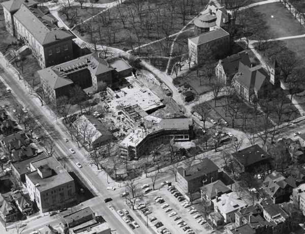 Aerial view of Chadbourne Hall under construction on the University of Wisconsin-Madison campus. The new building is at the corner of Park Street and University Avenue. Music Hall and part of Bascom Hill are on the right.