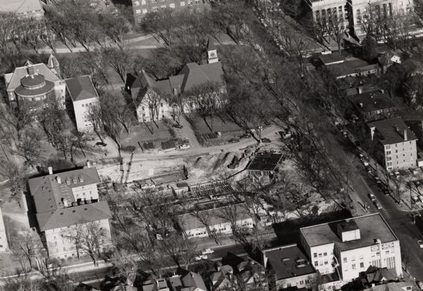 Aerial view of Chadbourne Hall under construction on the University of Wisconsin-Madison campus at the corner of Park Street and University Avenue. Music Hall and other buildings can be seen along Bascom Hill.