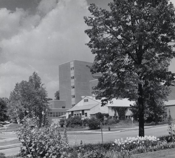 View across road of E.B. Fred Hall, the first home of the bacteriology department, on the University of Wisconsin-Madison campus. The building is set behind a long building on the corner of Linden Drive and Babcock Drive.