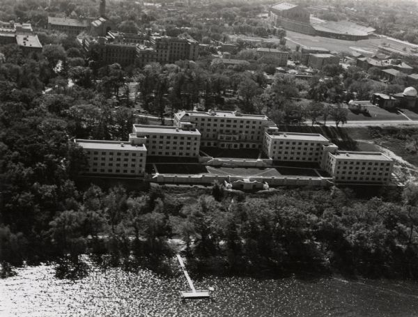 Aerial view of the Elizabeth Waters women's dormitory on the University of Wisconsin-Madison campus. In the upper right corner is Camp Randall. A long pier extends into Lake Mendota.