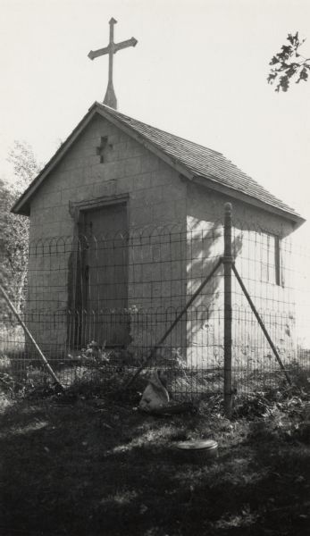 Chapel located in Indian Lake Park. It is a small, one-room building.  A large cross is on the roof over the entrance, and a fence surrounds the building.