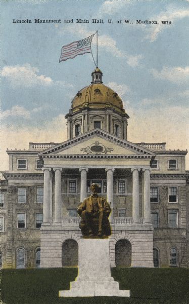 Front view of Lincoln Monument on the University of Wisconsin-Madison campus. In the background is Bascom Hall (labeled as Main Hall on the image). A flag waves from the dome of Bascom Hall. Caption reads: "Lincoln Monument and Main Hall, U. of W., Madison, Wis."