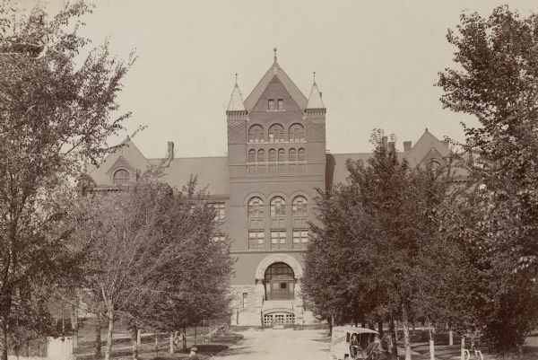 Front view of Science Hall, looking west down Langdon Street on the University of Wisconsin-Madison campus. A horse-drawn laundry vehicle is visible at the bottom of the photograph.