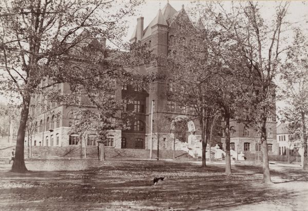 View through trees and lawn towards the northwest across Park Street of Science Hall on the University of Wisconsin-Madison campus.