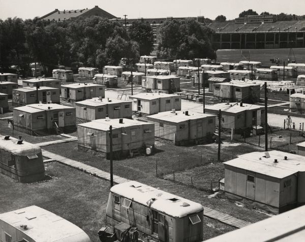 Elevated view of University of Wisconsin-Madison student housing project at Monroe Street. There was housing at Monroe Street and Randall Avenue for married veterans in the Camp Randall vicinity. Living units were trailers and army-style prefabs. There were two other such student housing projects, one at Badger Ordnance Works near Baraboo, and one at Truax Air Field in Madison. These living conditions were necessary because of the severe post-war housing shortage.