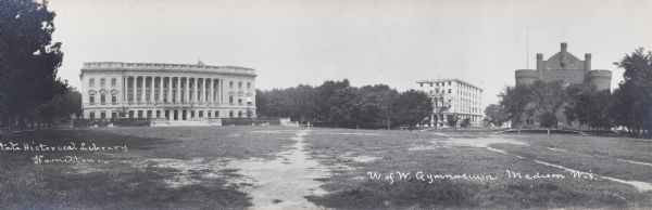 Panoramic view of University of Wisconsin-Madison campus, with the Wisconsin State Historical Library, old Y.M.C.A., and Armory (Red Gym or Old Red). The buildings surround an open area with worn walking paths.