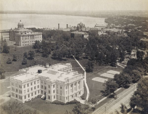 Elevated view over University Avenue towards the northeast of Bascom Hall and Lake Mendota on the University of Wisconsin-Madison campus. The Chemistry Building is in the foreground. Visible at right center may be the construction site of Lathrop Hall, completed in 1910.