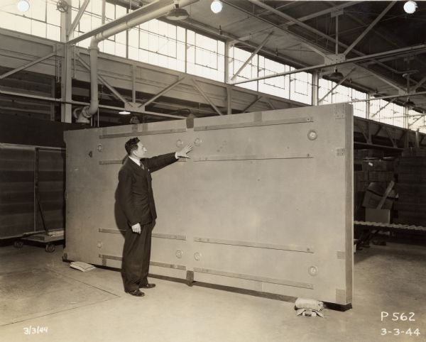 CG-4A glider floor manufactured by Consolidated Water Power and Paper Company, as part of a World War II military contract. Executive Jim Plzak is examining the glider floor.