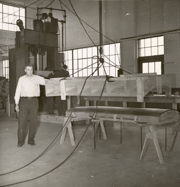 Carl Husome, an employee of the Consolidated Paper Company in a photograph probably taken to demonstrate progress on the development of a prototype for a military glider during World War II.