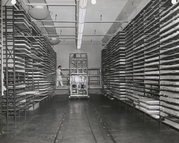 Storage area and hydraulic lift of a Consolidated Papers company factory, probably the company's plastics subsidiary Consoweld.