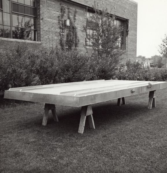 Glider floor constructed of a paper-based plastic laminate manufactured by the Plastics Division of Consolidated Papers Company of Wisconsin Rapids during World War II.  The date of the photograph and the fact that it has been carried outside the factory to be photographed suggests that this is the prototype glider floor.
