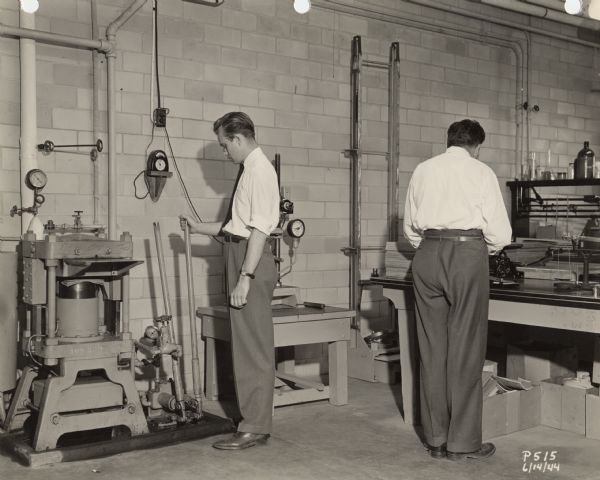Laboratory of the Plastics Division of the Consolidated Papers Company of Wisconsin Rapids. The man on the left has been identified as chemist Jay Somers, who was hired in 1942 to establish the program to develop a paper-based plastic laminate for military use during World War II.  The division later became known as Consoweld and Somers was appointed its general manager and vice-president.