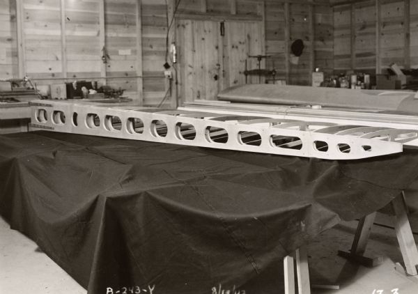 Photograph of work done by the Plastics Division of Consolidated Papers Company of Wisconsin Rapids in the development of paper-based plastic laminate during World War II, probably documenting a prototype glider part.