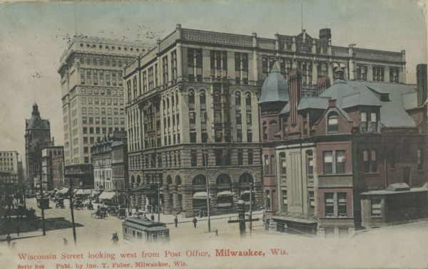 Elevated view looking across Wisconsin Street. The Hotel Pfister is on the corner. Caption reads: "Wisconsin Street looking west from Post Office, Milwaukee, Wis."