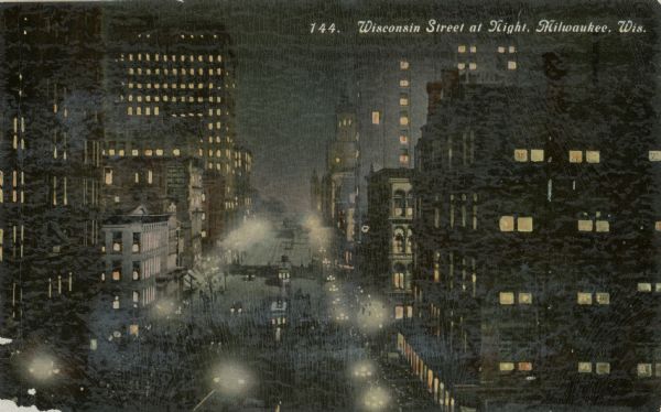 Elevated view of street at night. Caption reads: "Wisconsin Street at Night, Milwaukee, Wis."
