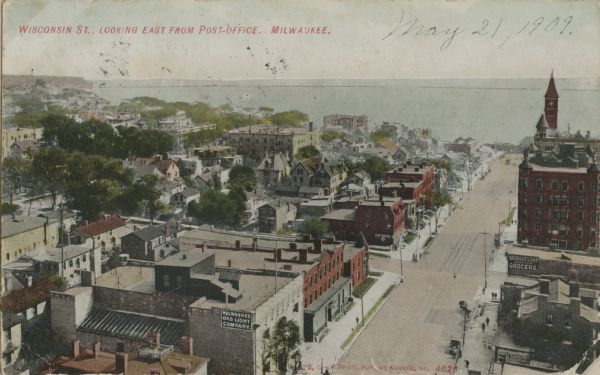Elevated view of Wisconsin Street, looking east from the Post Office towards Lake Michigan. Date written in pencil on postcard reads May 21, 1909. Caption reads: "Wisconsin St., looking East from Post-Office. Milwaukee."
