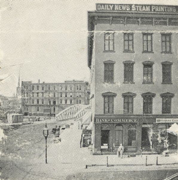 East Water Street and Wisconsin Street, northwest corner; this is also called the Ludington Block. The Spring Street and Booth Building are in the background.