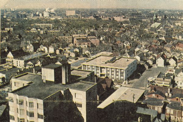 Elevated view of city looking west, showing breweries and the center of the city.