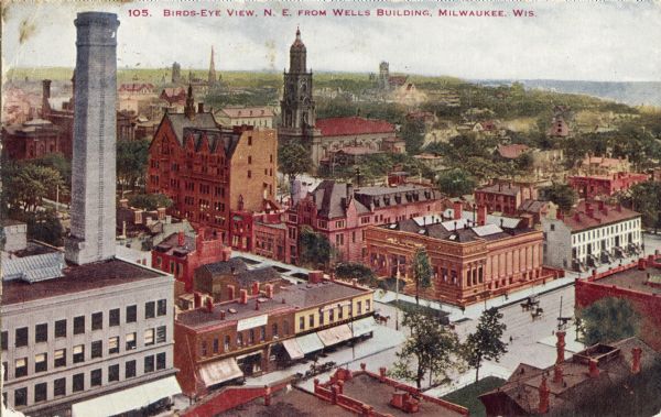 Elevated view looking northeast from the Wells Building showing the St. Johns Cathedral, the Masonic Temple and the Emanuel Church, among other buildings. Caption reads: "Birds-Eye View, N. E. from Wells Building, Milwaukee, Wis."