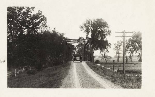 The Milwaukee Journal Pathfinder car driving from a road onto a bridge.