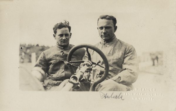 The person on the right is Frank Kulick, who worked on and drove some of Henry Ford's early race cars. The individual on the left is unidentified.