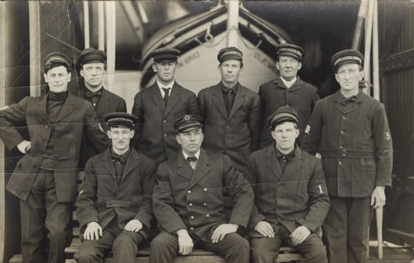 Group of men of the Life Saving Service posing in front of their boat.