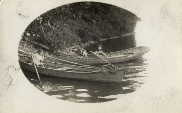 Along a wooded shoreline, three children (probably J. Robert Taylor's two daughters and son)are  in two boats playing. In one boat a young boy in white is struggling to move two large oars. In the other boat, a girl in back is holding onto the left oar, while the other girl is sitting with her chin resting on her hand, looking towards the shore.