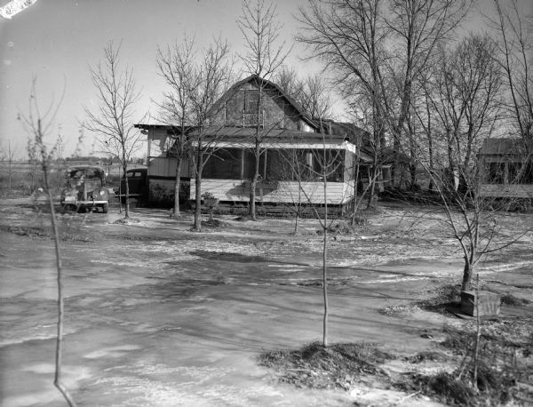 A lodge in winter. The yard of the lodge is covered in ice.