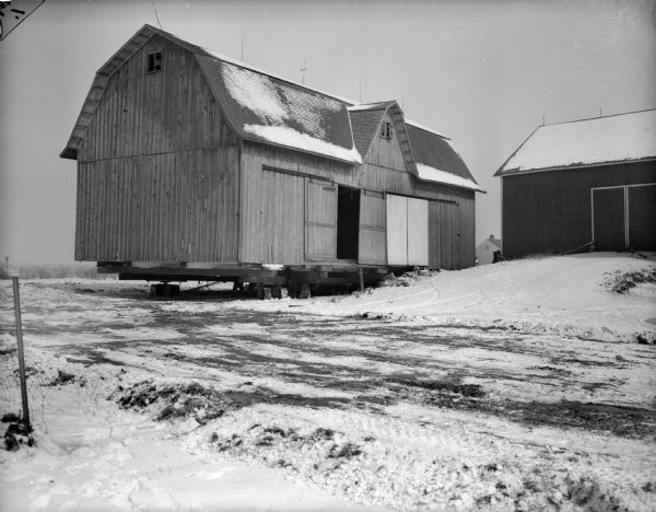 The Taylor barn on a platform. On the right is another barn on top of a small incline.