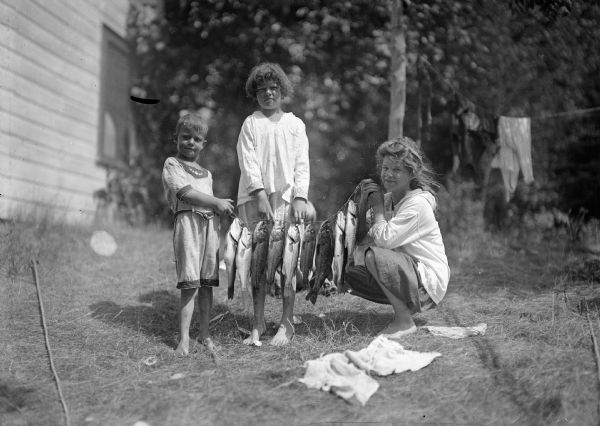 J. Robert Taylor's children holding a stringer of fish. From left: Fred Taylor, Ellen Taylor Higgins, Donna Taylor Adams.
