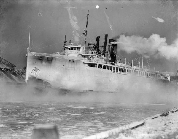 An ice-covered car ferry, possibly docking in a harbor.