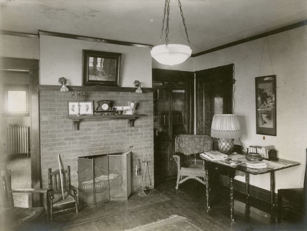 Interior view of the living room of the Richard Lloyd Jones residence, 1010 Walker Court (now called Rutledge Court)showing the fireplace. A Japanese print which was given to the family by Frank Lloyd Wright (a cousin), hangs on the wall above an antique table originally belonging to his wife's Mead family of Greenwich, Connecticut. According to the Lloyd Jones family, "George Washington frequently visited the Meads, so he might have written or eaten at this table."