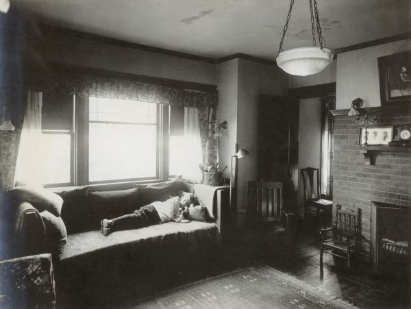 Jenkin Lloyd Jones, born Nov. 1, 1911, sleeping on the sofa in the living room of his parents, the Richard & Georgia Lloyd Jones, home 1010 Walker Court (now 1010 Rutledge Court).