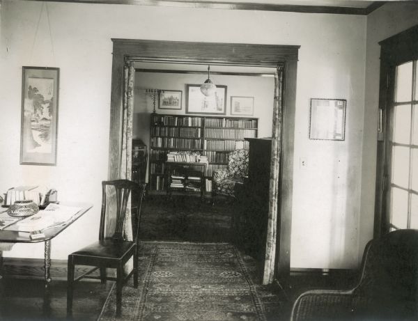 A view from the living room into the library of the Richard Lloyd Jones residence, 1010 Walker Court (now called Rutledge Court).  He was editor and publisher of the <i>Wisconsin State Journal</i>. On the wall to the left of the doorway is a Japanese print given to the family by Frank Lloyd Wright, a cousin; below it is an antique table from Greenwich, Connecticut.  A menorah on the library bookcase was purchased by Georgia Lloyd Jones when they lived in New York.