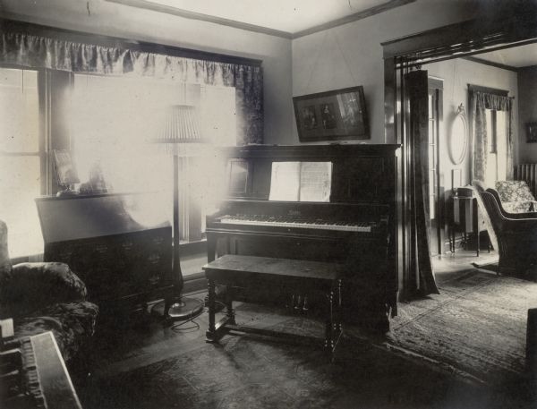 A view from the library into the living room of the Richard Lloyd Jones residence, 1010 Walker Court (now 1010 Rutledge Court). He was editor and publisher of the <i>Wisconsin State Journal</i>. A Cable piano and secretary desk stand in the library.