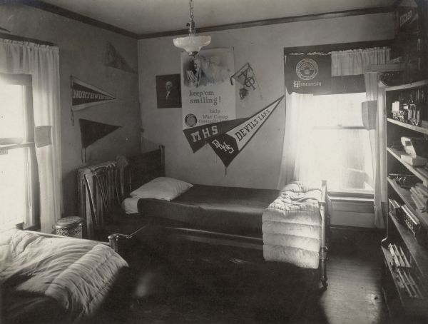 The boys' bedroom of the Richard Lloyd Jones residence, 1010 Walker Court (now 1010 Rutledge Court). Several pennants decorate the walls, including those of Madison High School and Devil's Lake High School, Northwestern University and the University of Wisconsin. A World War I era poster for War Camp Community Service also hangs on the wall.