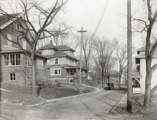 The Richard Lloyd Jones family car parked in front of the residence at 1010 Walker Court (now 1010 Rutledge Court).  House to the left is 617 South Brearly and house on the right is 1005 - 1007 Walker Court.